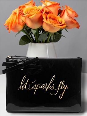 Kate Spade " Let Sparks Fly" Georgie Clutch Gold Script on Black Patent.